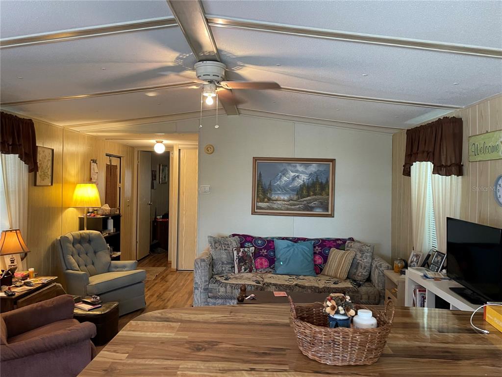 251 Patterson Road, Unit C25 Haines City, FL 33844 - Photo 6 of 10 a living room with furniture and a flat screen tv