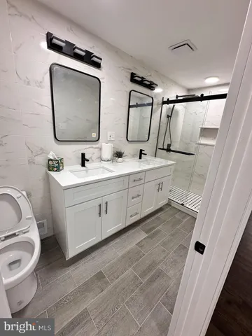 an empty room with wooden floor ceiling fan and window