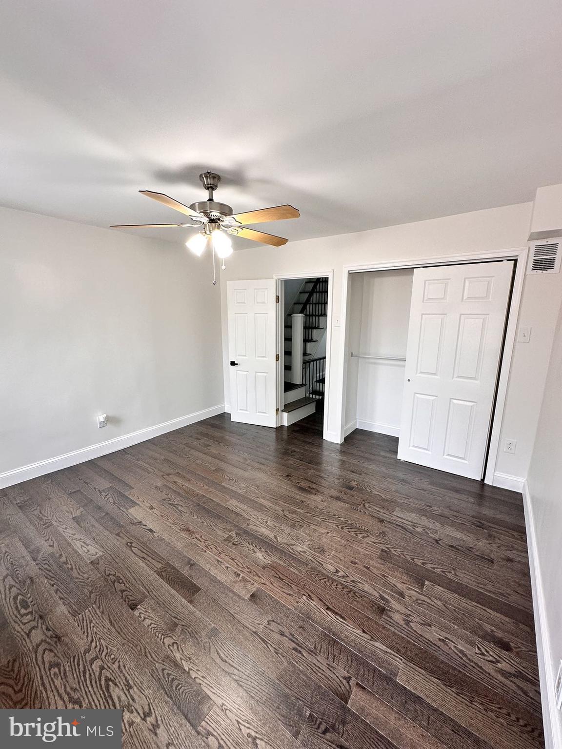540 Manton Street Philadelphia, PA 19147 - Photo 17 of 25 an empty room with wooden floor ceiling fan and window