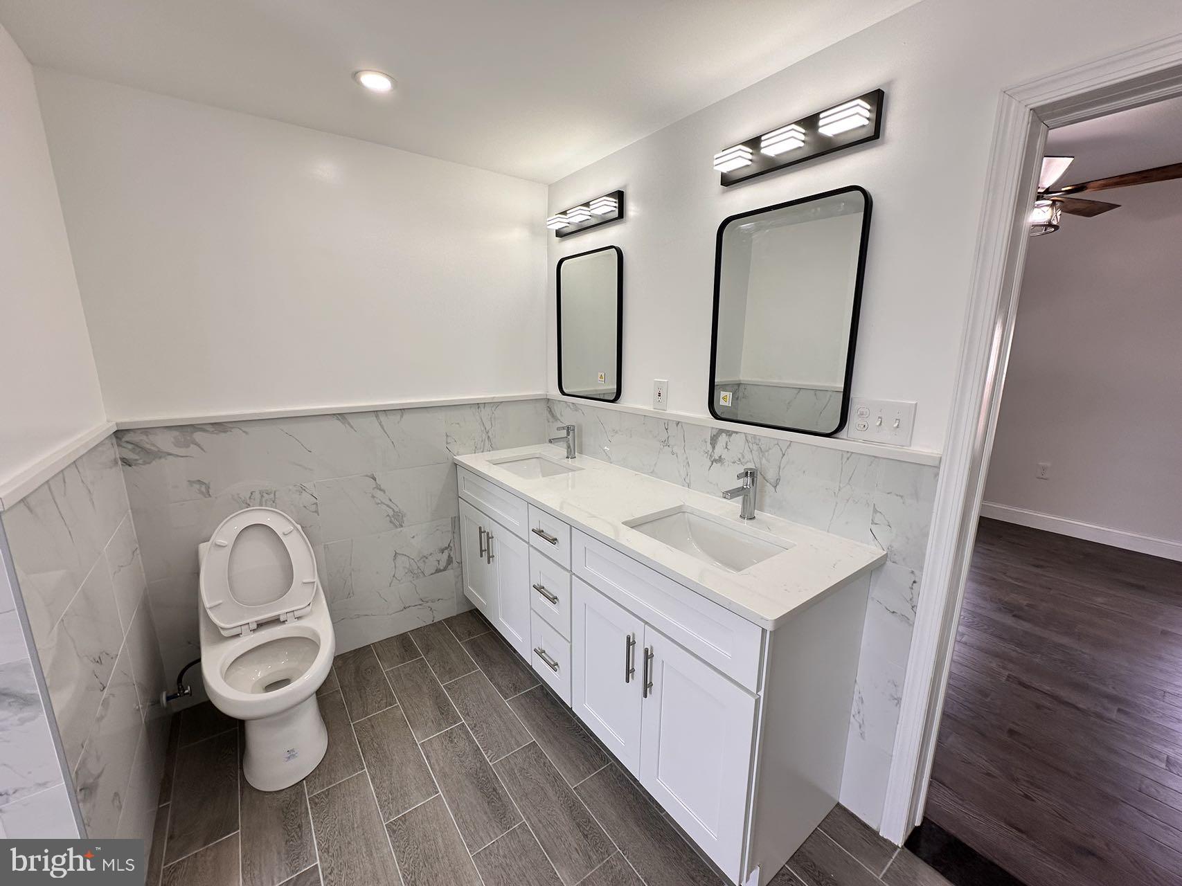 540 Manton Street Philadelphia, PA 19147 - Photo 20 of 25 a bathroom with a double vanity sink and a mirror