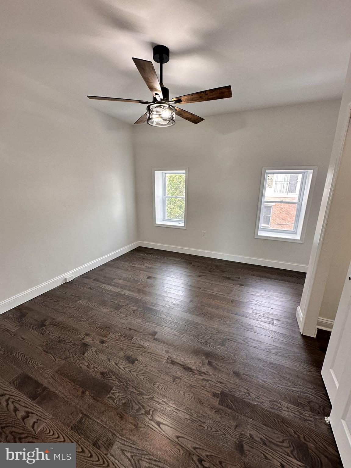 540 Manton Street Philadelphia, PA 19147 - Photo 21 of 25 an empty room with wooden floor chandelier fan and windows