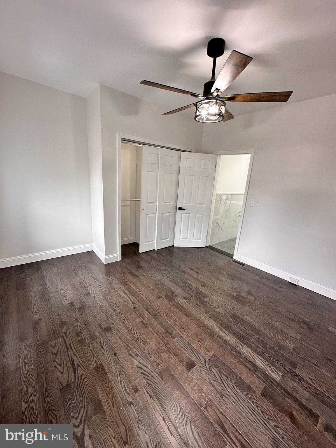 540 Manton Street Philadelphia, PA 19147 - Photo 22 of 25 an empty room with wooden floor ceiling fan and windows