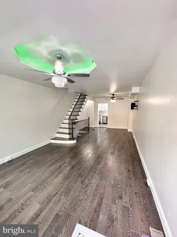 a view of a room with wooden floor