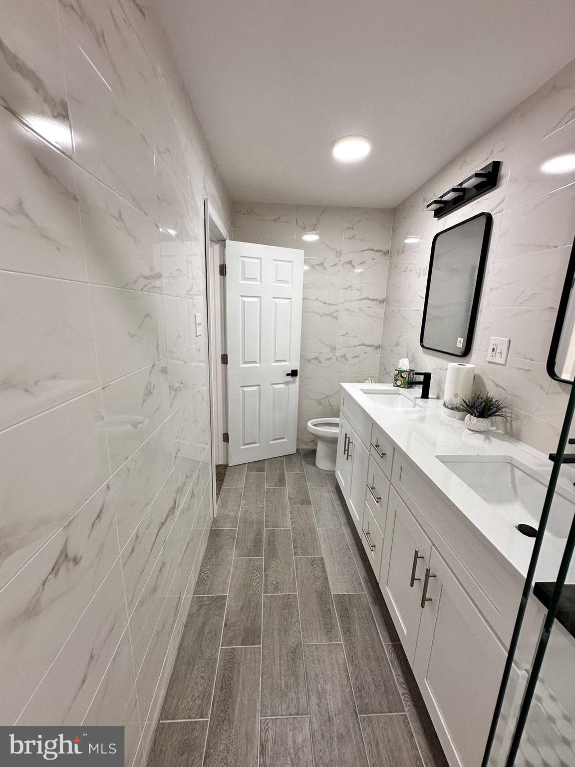 540 Manton Street Philadelphia, PA 19147 - Photo 10 of 25 a spacious bathroom with a double vanity sink and a mirror