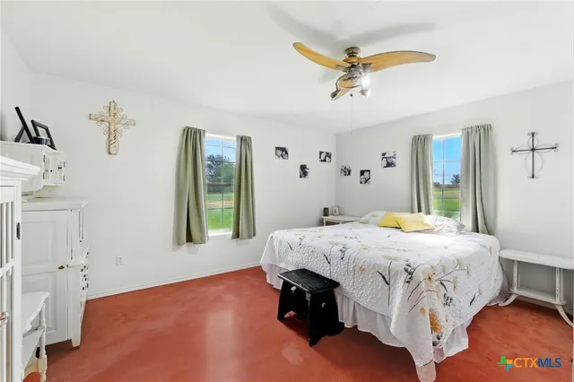 a room with a table chairs and a window