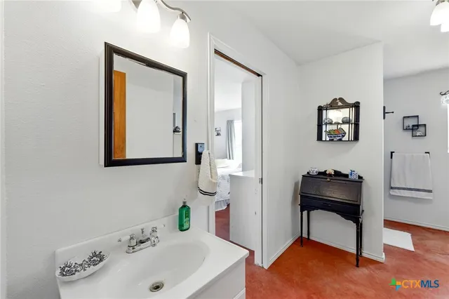 a living room with furniture a window and a flat screen tv