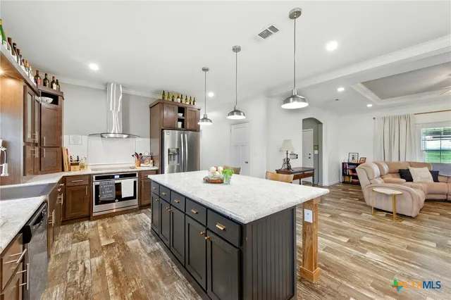 a open kitchen with a table chairs and white cabinets