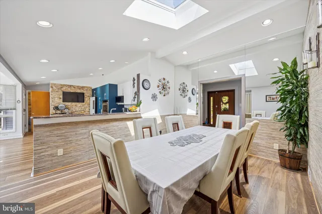 a view of a dining room with furniture and a kitchen
