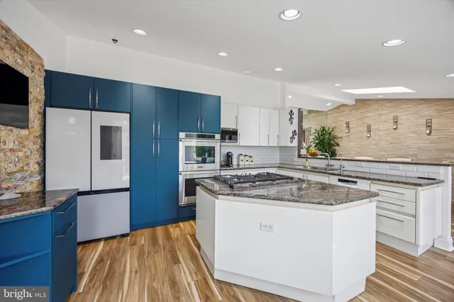 a kitchen with a sink a stove a refrigerator and a microwave