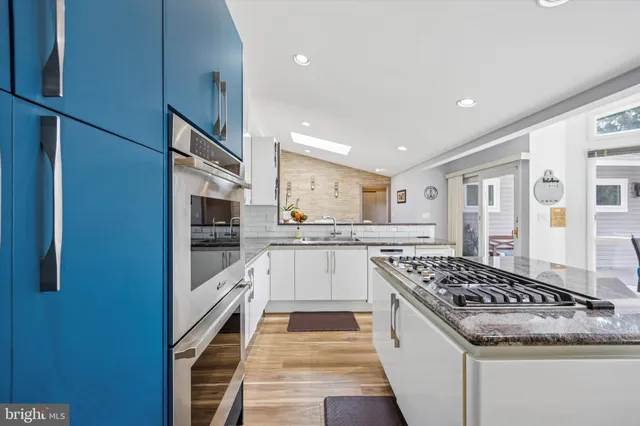 a kitchen with stainless steel appliances granite countertop a stove and a refrigerator