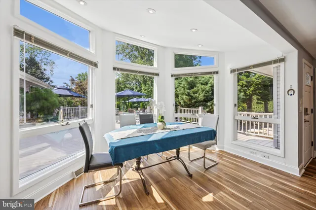a view of a dining room with furniture large windows and wooden floor