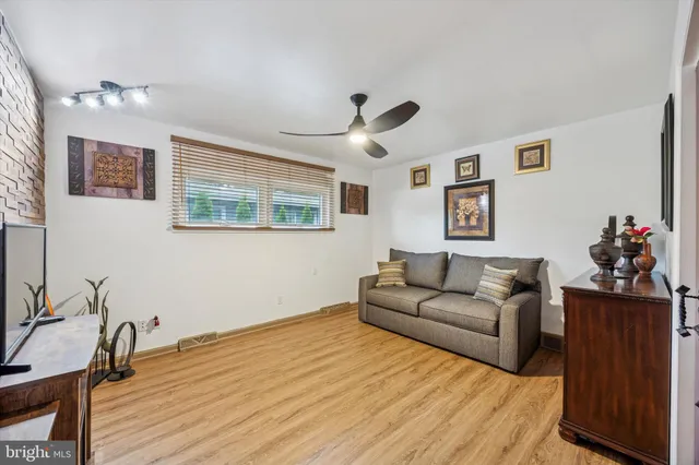 a bathroom with a sink a toilet a mirror and shower