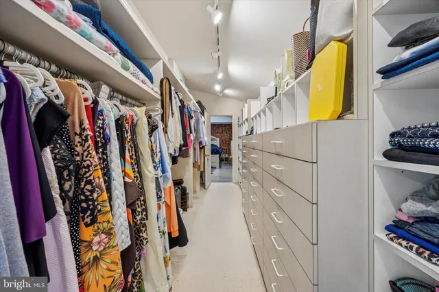 a bedroom with furniture and a flat screen tv