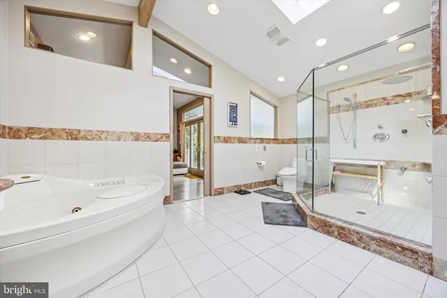 a view of a house with wooden deck and sitting area