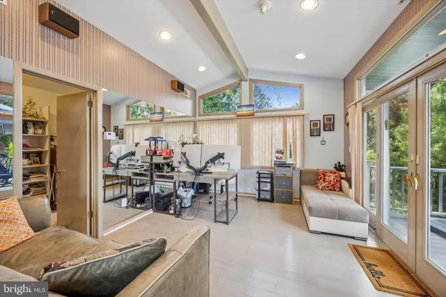 a view of a patio with table and chairs and potted plants with wooden floor and fence