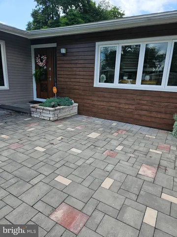a view of a brick house with a bench in front of it