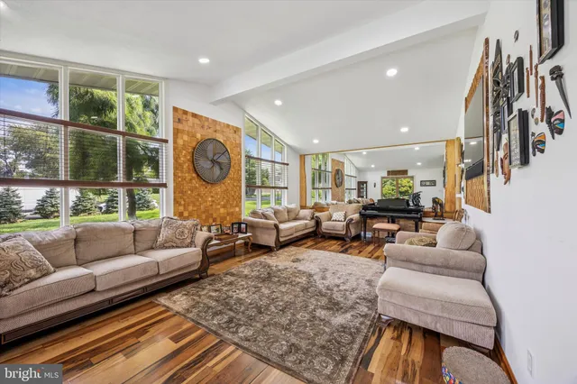 a living room with furniture and a floor to ceiling window