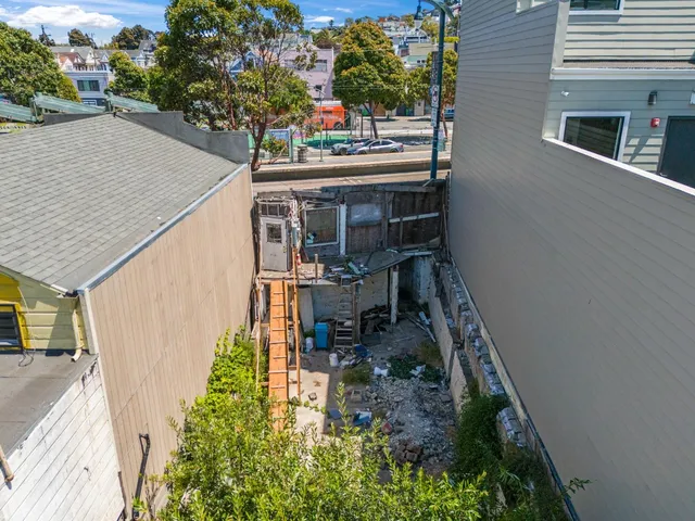 a view of a house with pool and sitting area
