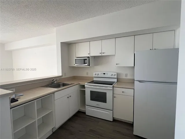 a view of a kitchen with wooden floor