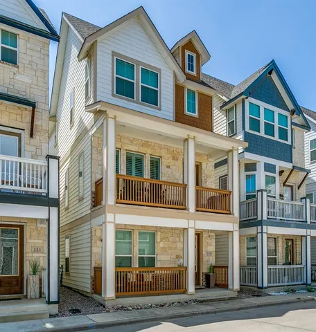 a front view of a residential apartment building with a yard