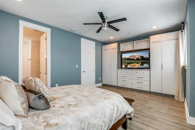 a bedroom with a bed and a flat screen tv