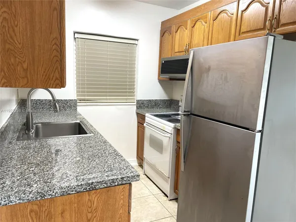 a kitchen with a refrigerator and a sink