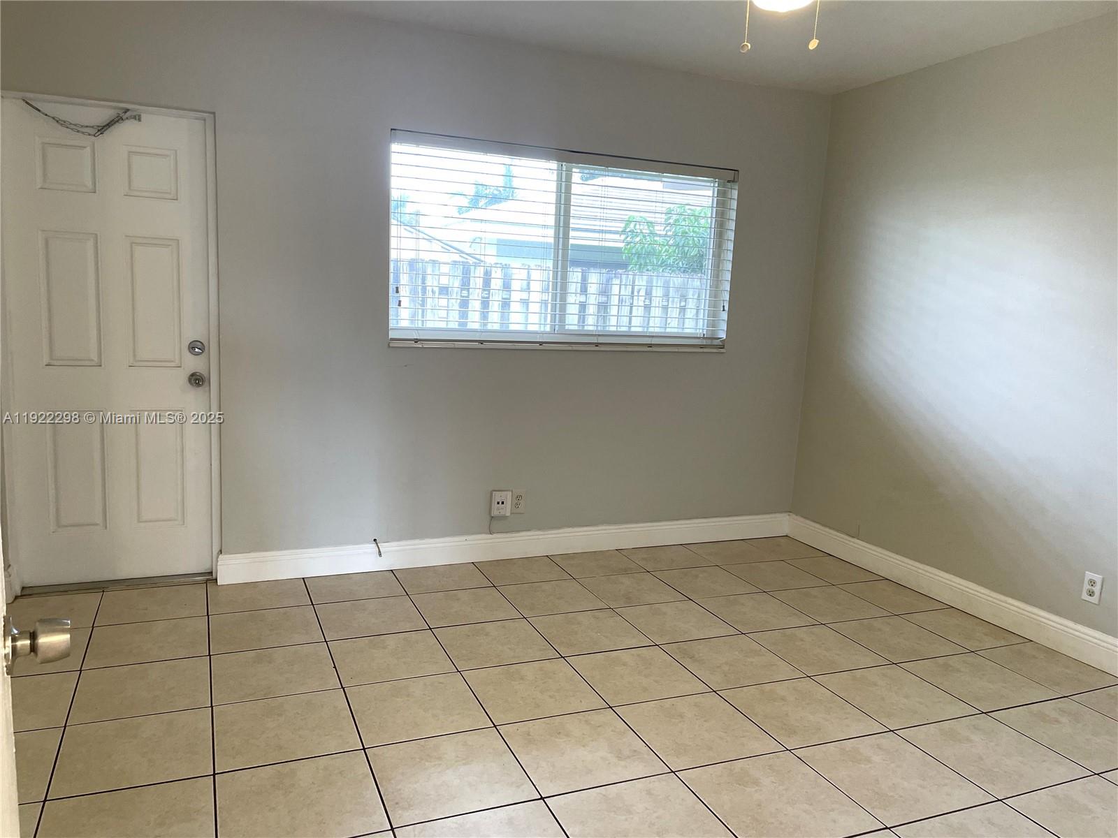 2121 Northeast 40th Court, Unit 2 Lighthouse Point, FL 33064 - Photo 7 of 11 an empty room with windows