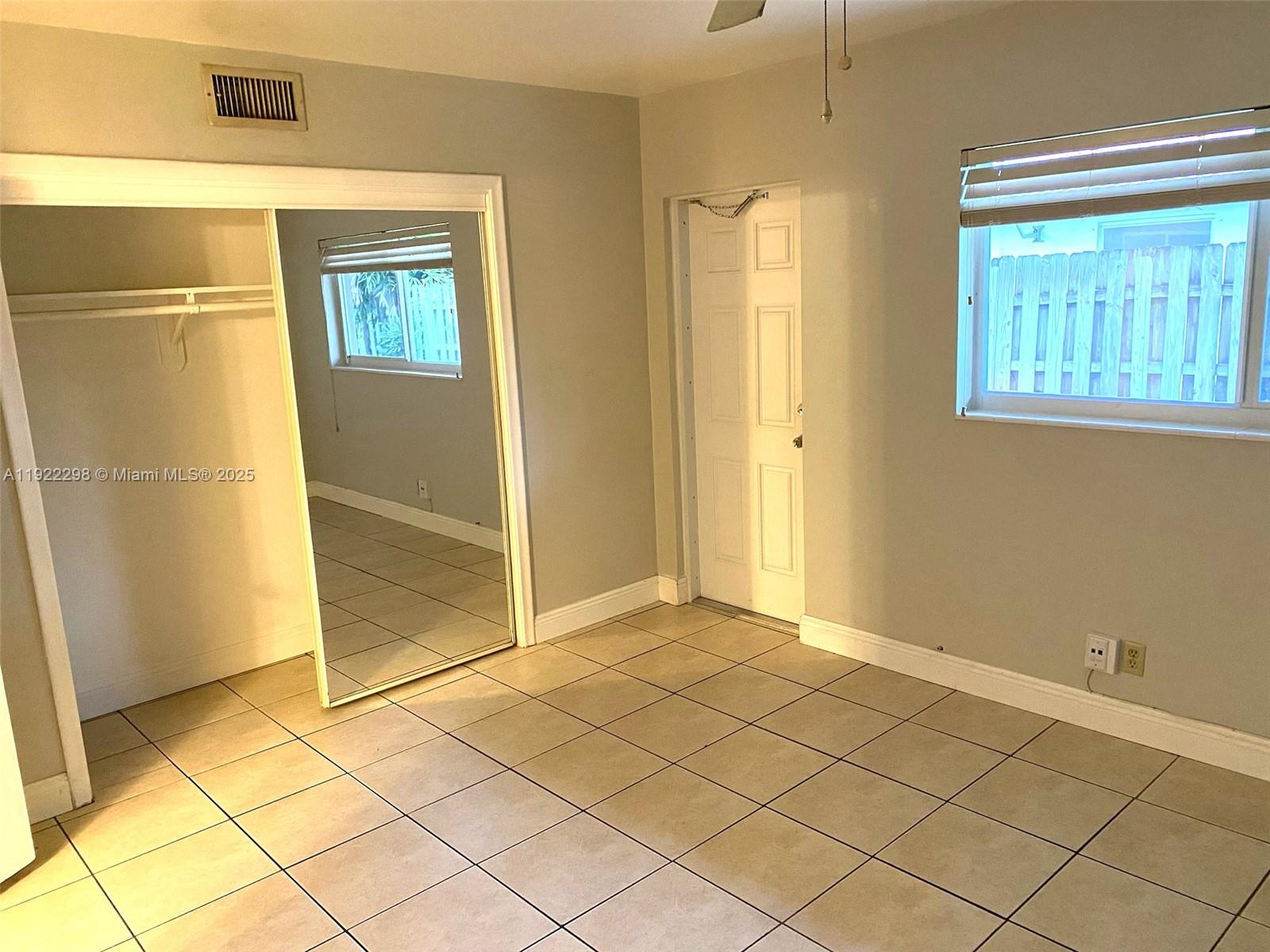 2121 Northeast 40th Court, Unit 2 Lighthouse Point, FL 33064 - Photo 8 of 11 a view of an empty room and window