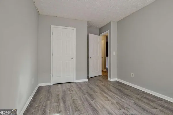 an empty room with wooden floor