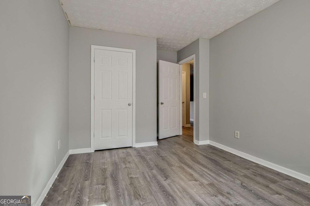 1915 Grove Way Hampton, GA 30228 - Photo 21 of 25 an empty room with wooden floor
