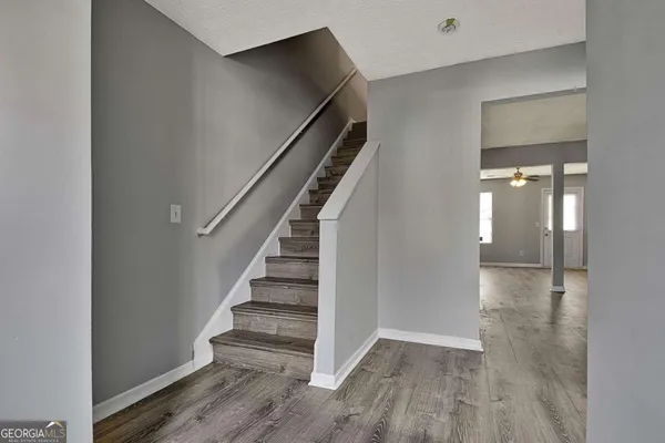 a view of entryway and hall with wooden floor