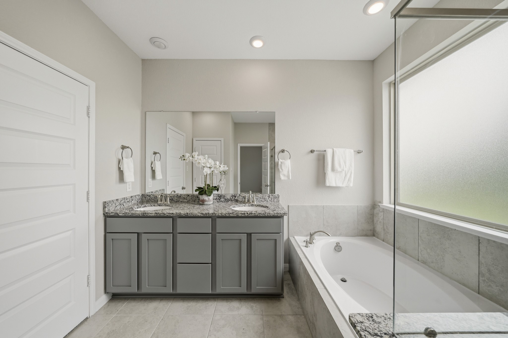 4103 Tranquil Square Road Houston, TX 77043 - Photo 22 of 39 The primary bath pairs a granite counter with dual sinks, classic 12x12 tile flooring and recessed lighting for a polished, spa-inspired feel.