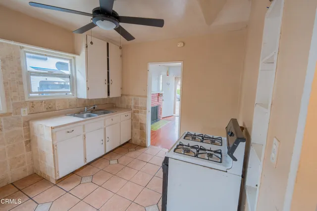 a kitchen with a sink cabinets and appliances