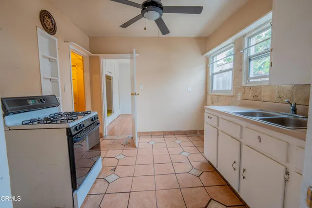 a kitchen with stainless steel appliances a stove a sink and a refrigerator
