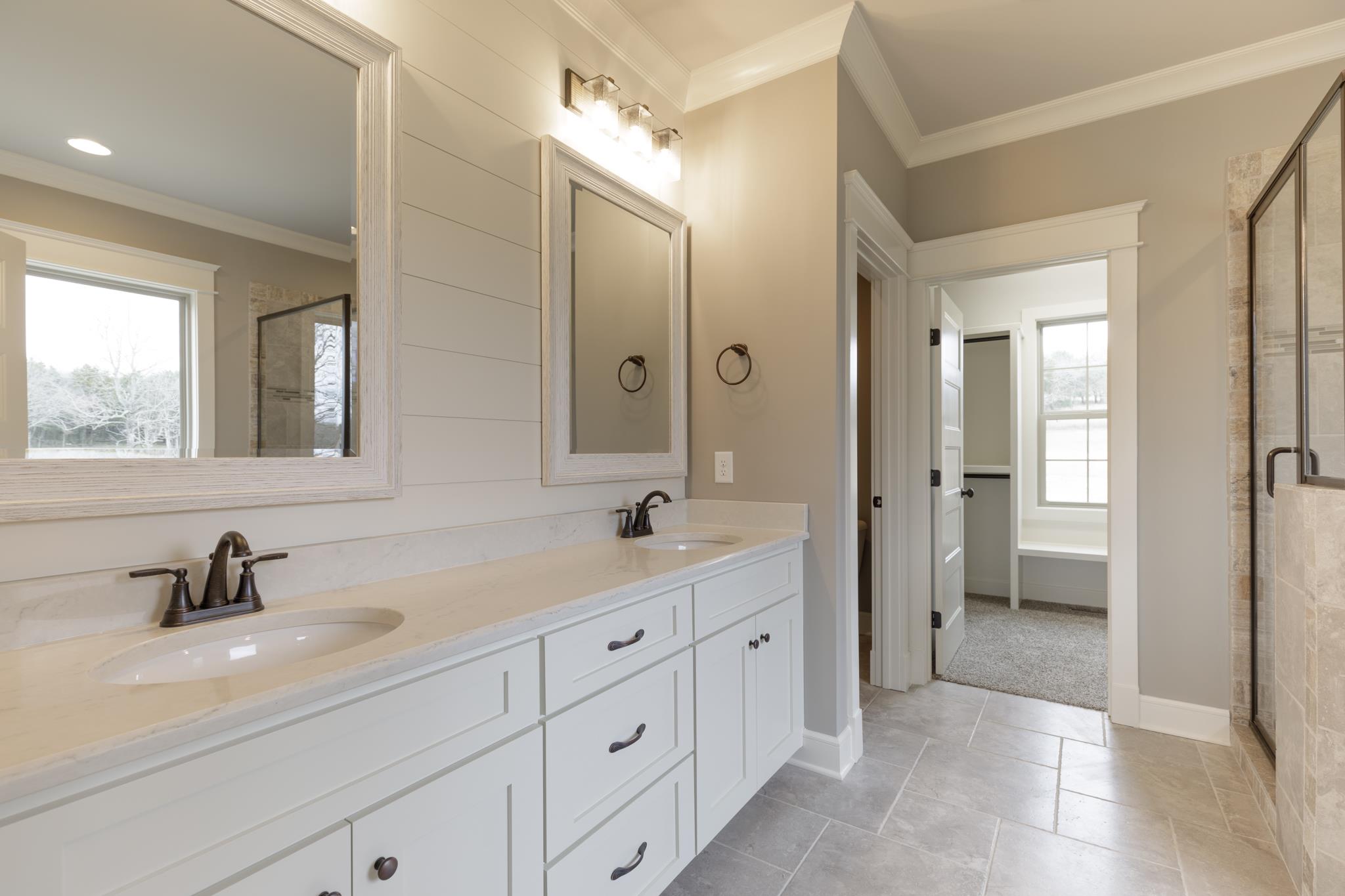 1720 Dillon Road Milton, TN 37118 - Photo 18 of 30 a bathroom with a double vanity sink and mirror with shower