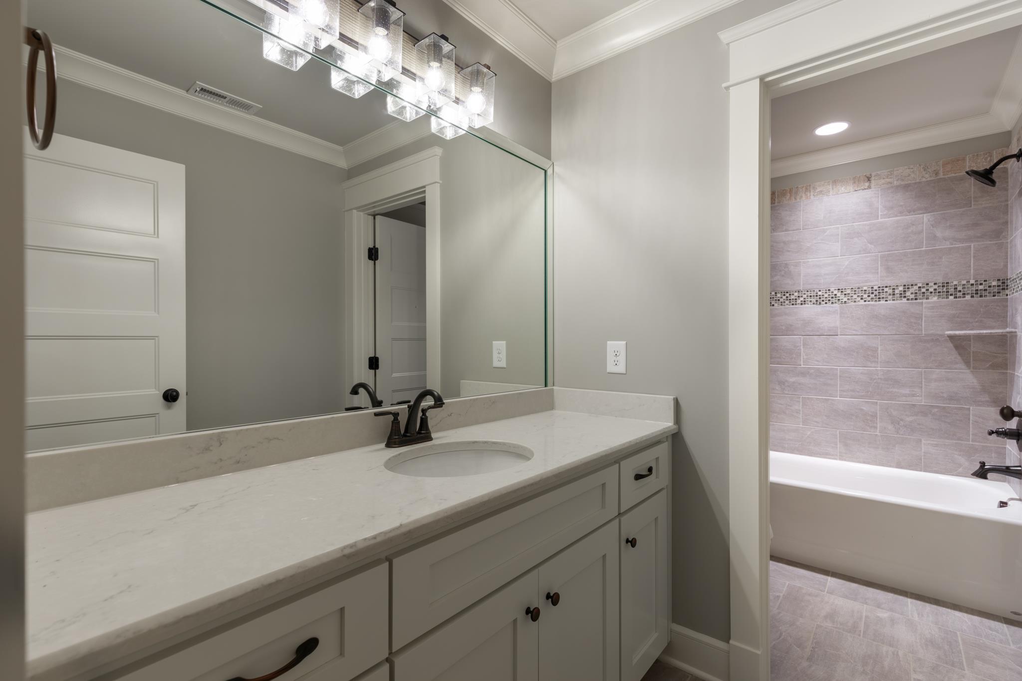1720 Dillon Road Milton, TN 37118 - Photo 25 of 30 a bathroom with a sink double vanity granite tub shower and a mirror