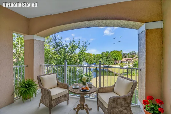 a balcony with outdoor seating and plants