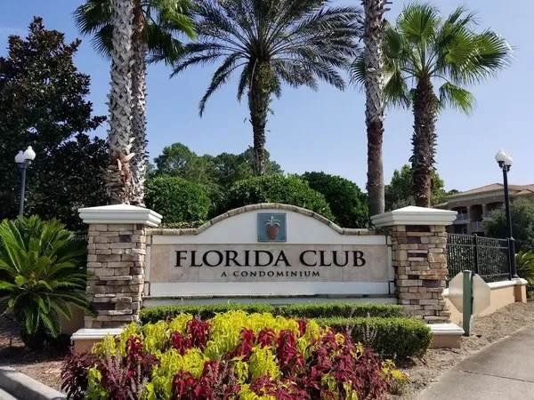 a view of sign board with flower garden