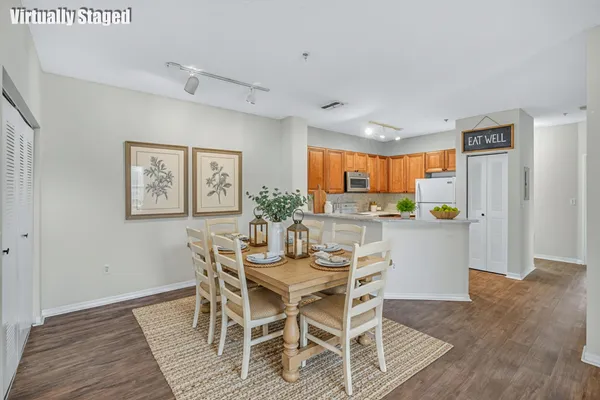 a view of a dining room with furniture and wooden floor