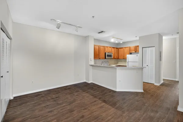a view of a kitchen with a sink and a refrigerator