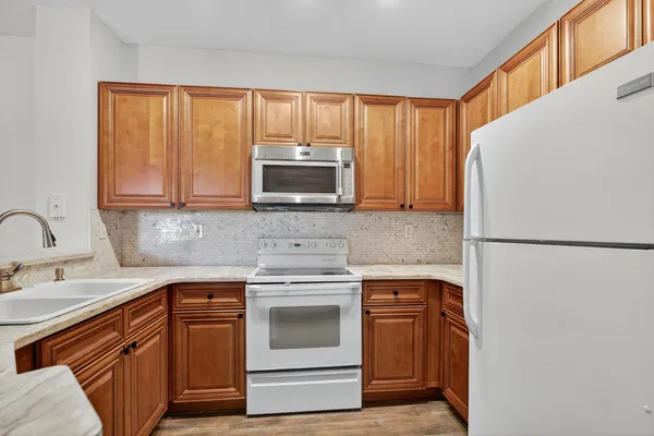 a kitchen with appliances a sink and a microwave