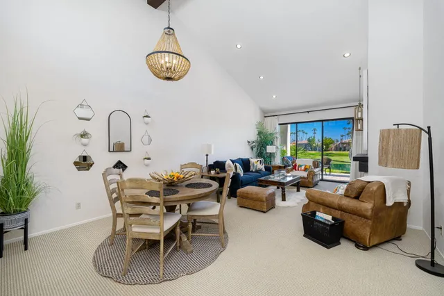 a dining room with furniture a chandelier and a rug