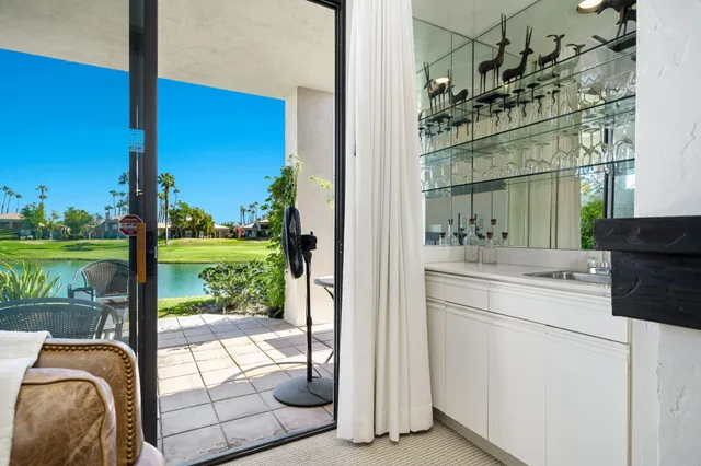 a room with a bed and a balcony view