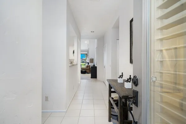a kitchen with stainless steel appliances refrigerator dining table and chairs