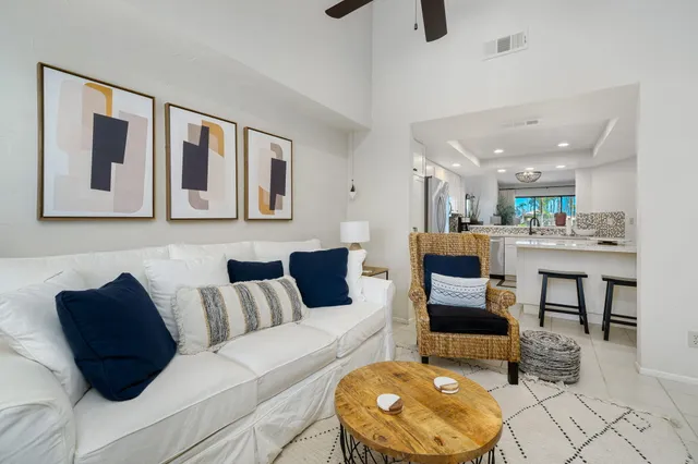 a living room with furniture and kitchen view