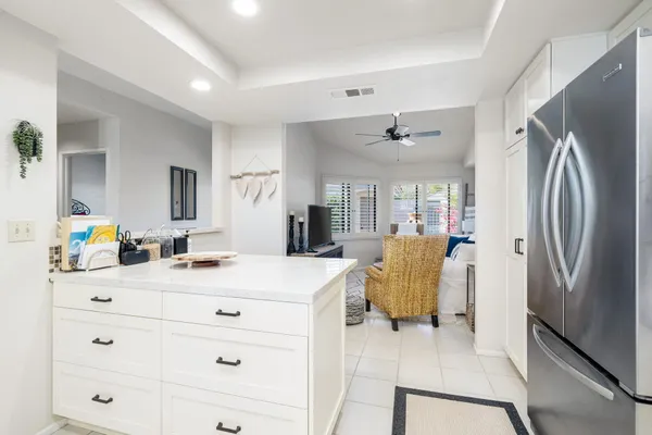 a en suite bathroom with a granite countertop sink and a mirror