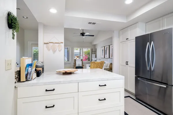a kitchen with refrigerator cabinets and wooden floor