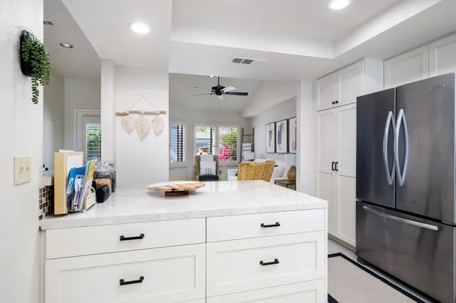 a kitchen with refrigerator cabinets and wooden floor
