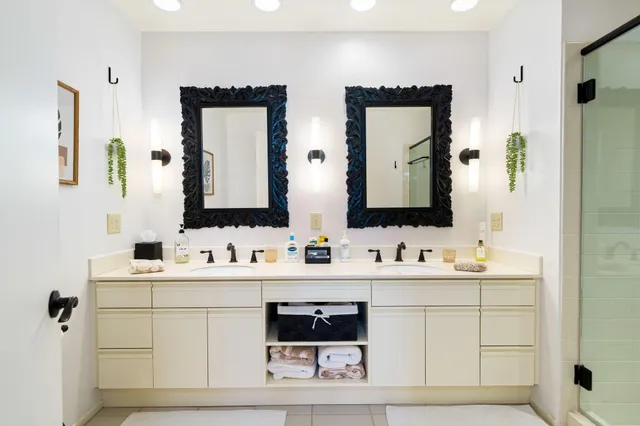 a bathroom with a double vanity sink and mirror