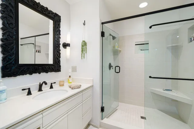 a bathroom with a sink a toilet and shower